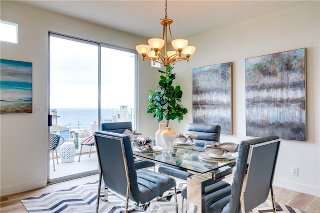 The dining room is perfect for intimate dinner parties but also opens up to the main living space for larger gatherings. The sliding glass doors provide a beautiful view.