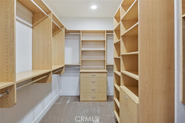 gorgeous walk in closet with built ins in the master closet