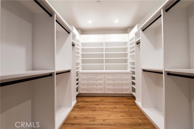 Master Bedroom Walk In Closet. Note the under shelf lighting and ample drawer space.