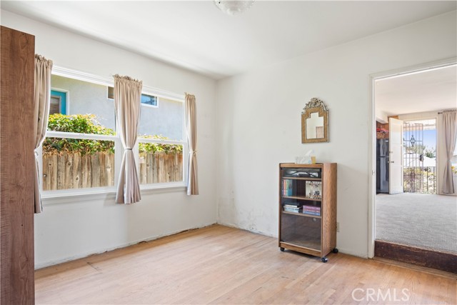 2nd bedroom leads to family room. Current owners had closed off the doorway and lived in the back (family room) and rented out the 2 bedroom house in front. This walk-through bedroom became a dedicated bedroom as the doorway was a wall.