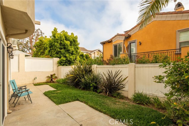 The grassy backyard is a great outdoor space for play, recreation, and relaxation.