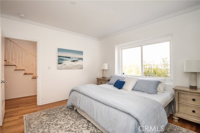 Bright and airy master bedroom with walk in closet and private bathroom . Beautiful new hardwood flooring