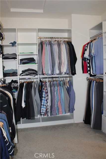 Many shelves and space in the walk-in master closet.