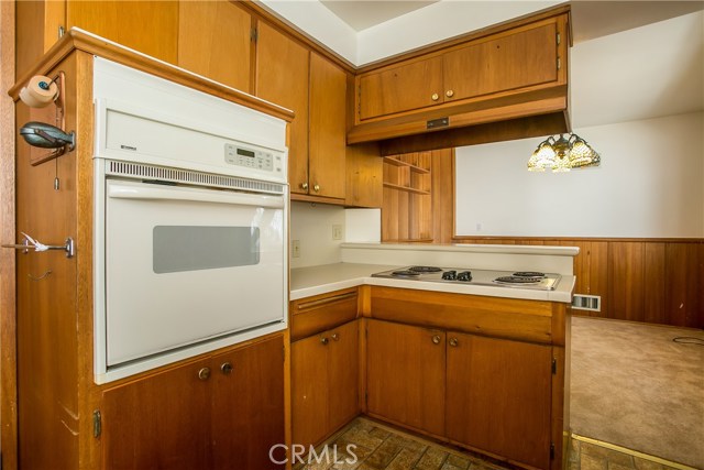 The kitchen cabinets have good storage areas and the bar counter overlooks the dining room.