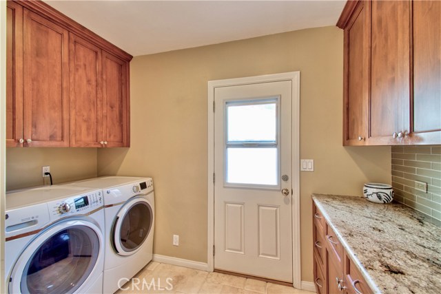 Laundry room with abundant cabinetry & counter space