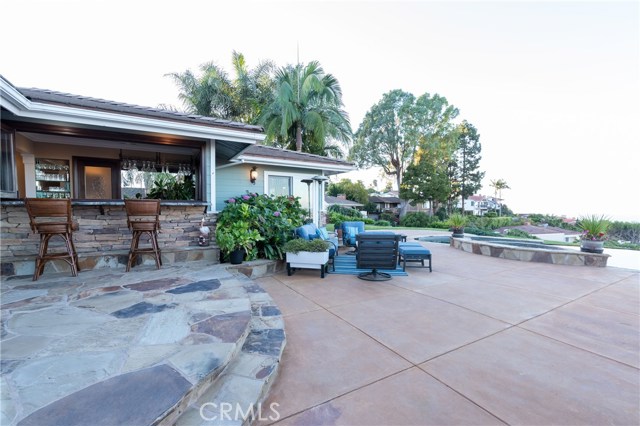 Fabulous indoor/outdoor bar area, with huge patio and pool and spa area beyond.