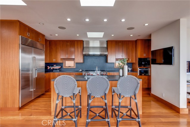 The chef's kitchen includes stainless steel appliances, built in coffee maker and walk-in pantry.