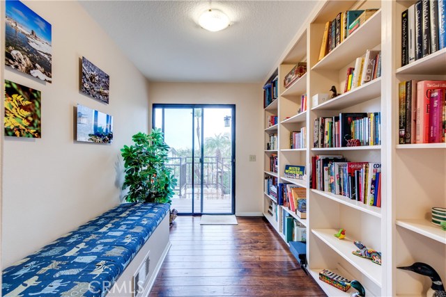 Built in library shelving creates a unique space as you head to the back yard