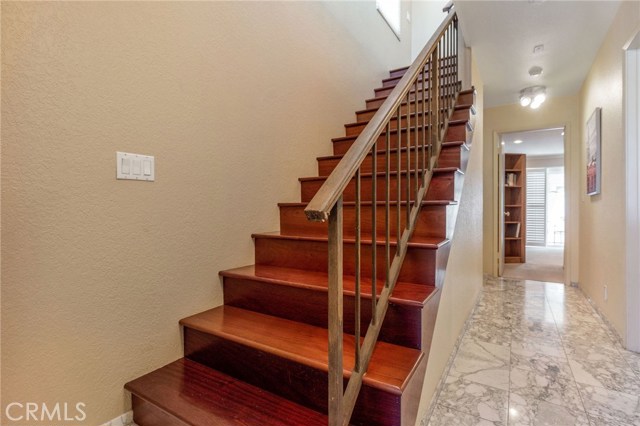 Cherry wood stairs leads up to 2nd level. Marble flooring in entry and first level (bedrooms) hallway.