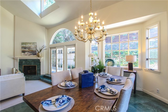 Formal Dining Room opening into Living Room with vaulted ceilings.