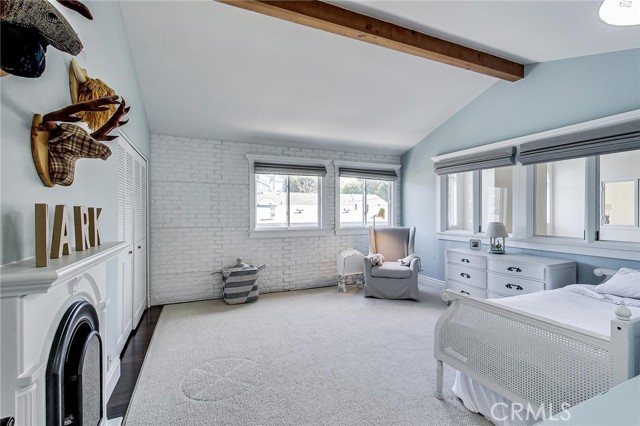 Let's call this bedroom #3. Vaulted beamed ceiling, windows looking down of living room (at right) and good sized closet at left. East facing windows straight ahead.