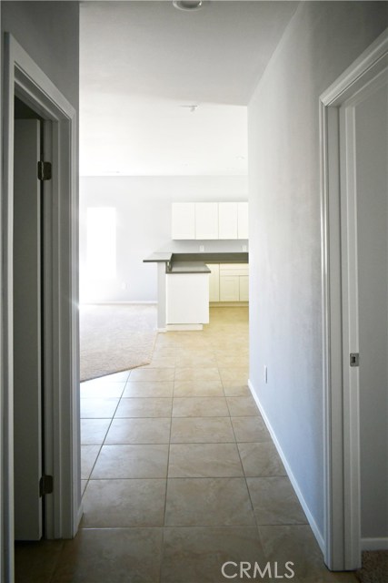 hallway facing living room & kitchen