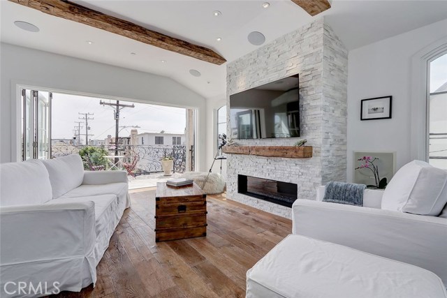 Top floor living room with linear gas fireplace, 100-year old barnwood beams