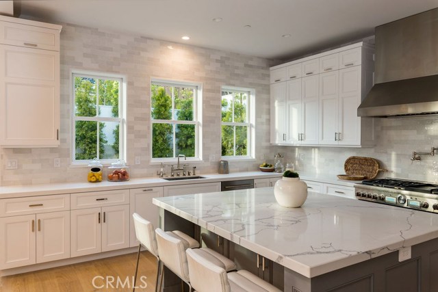 Expansive gourmet kitchen saturated in natural light