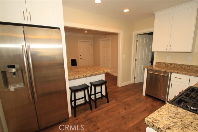 View from the kitchen looking toward the living room.  High end appliances including refrigerators, come with the units.