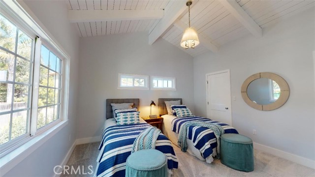 The 2nd upstairs bedroom could be for twins, two children or be masterbedroom if you choose. Notice the wood cathedral ceiling with exposed beams. There is a large walkin closet. Lots of sunlight, with the windows open feel and smell the beach breeze