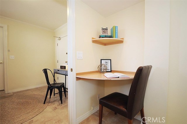 Downstairs den leading into 3rd bedroom with corner desk.