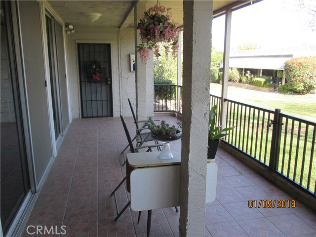 A part of the covered patio and the green grassy lawn.