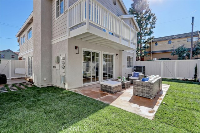 Newly landscaped backyard wrapping around to side patio all fenced in
