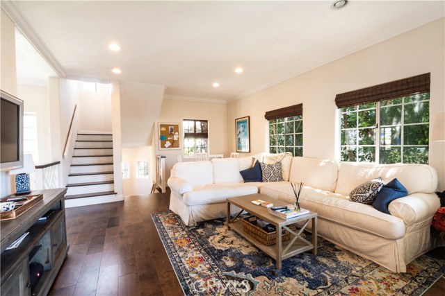 One of the 2 living room areas with gleaming hardwood floors and recessed lighting