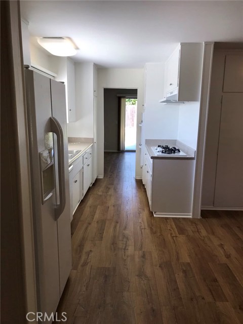 Kitchen looking back at entry to dining/living room