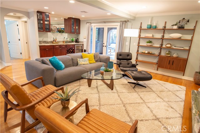 Family/living room with built-in wet bar connects to backyard making for indoor/outdoor entertaining effortless.