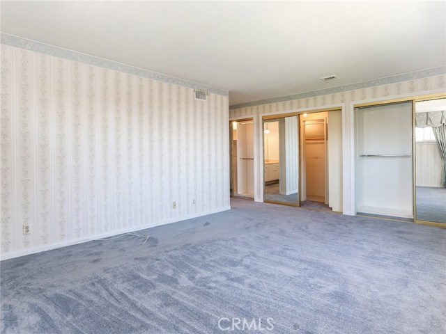 View of 3 closets, all with built-in shelves, in the Master