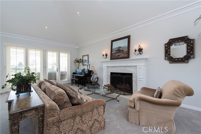 The living room has tall ceilings with crown moldings, beautiful fireplace with mantle, and doors that open to the rear yard!
