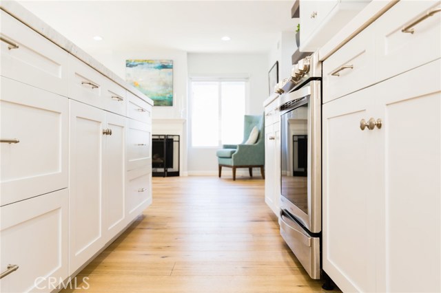 white Shaker style cabinets, hardwood floors