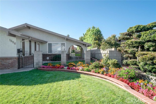 The owners have maintained the garden yard areas quite nicely.  Brick flowerbed extends to the back of the covered front entryway.  Gated front "wall" could be really nice with some upgrades. The roof appears to be in good condition and is only 14 years old.  The garage has a side door to the front walkway and the east side.
