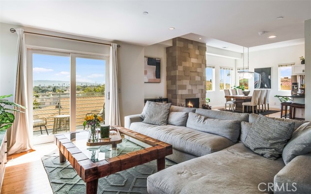 Expanded living room area showing the balcony and city views