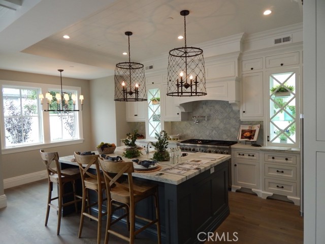 Custom Cabinetry in Kitchen with Breakfast Nook and Marble Counters