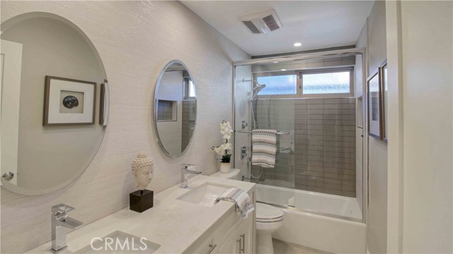 large main bathroom, glass enclosed tub/shower, tiled walls, glass tile wall in shower