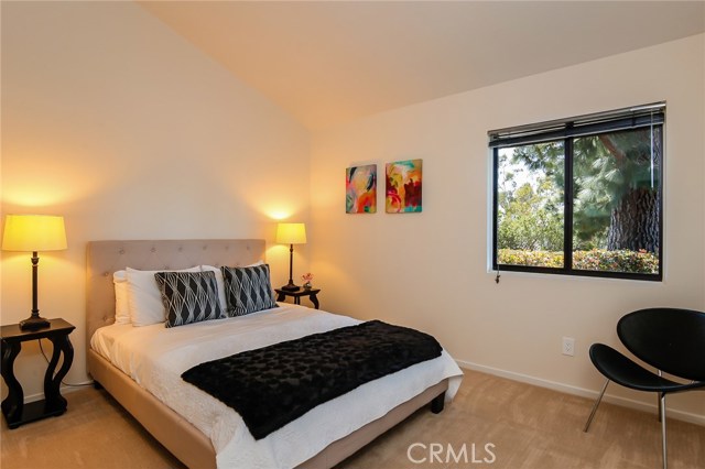 Enjoy the lush landscape from this second downstairs bedroom