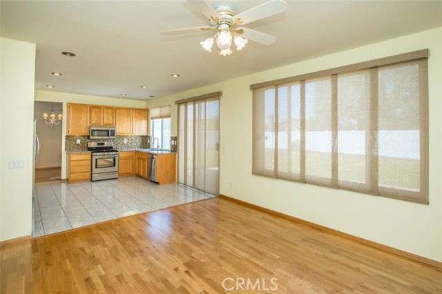 Family room open to kitchen, ceiling fan and Sliding screen blind for extra sun protection