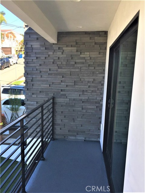 The Wraparound View Balcony off of the Upper Level, Front, Bar/Den/Game Room adjoins the Wide Stairway leading to the Huge Ocean View Roof Deck