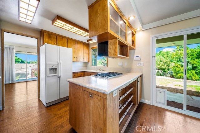 Kitchen with formal dining behind and family room to right.