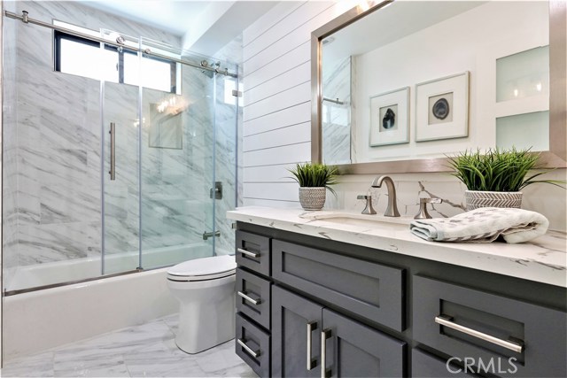 The home has 4 Full Baths.  This is the Lower Level Bathroom which features Porcelain Floors and Walls, Seamless Glass Enclosure, Large Vanity with self-closing drawers and cabinet doors and thick Slab Misty White Carrara Caesarstone counter surface
Moen or Kohler fixtures