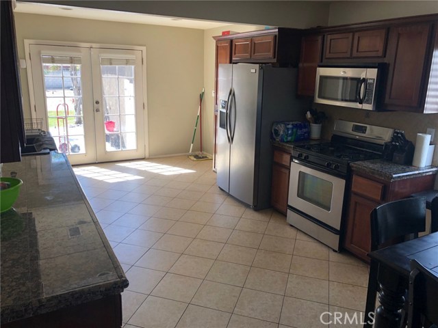 Another view of the kitchen and french doors leading to the backyard.