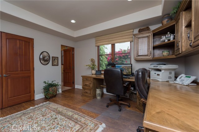Downstairs Bedroom #5 is currently being used as an office with built-ins. Full bathroom is beyond.  This would be PERFECT for in-laws, as it is on the mail level!