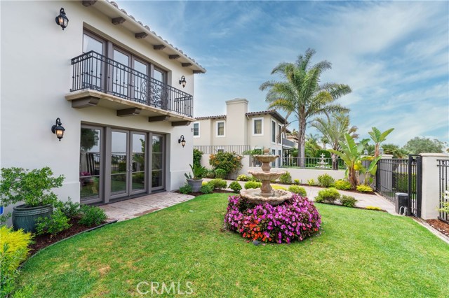 Beautiful front yard, with living room French doors below, and Master bedroom above.  Electronic opening gated driveway.