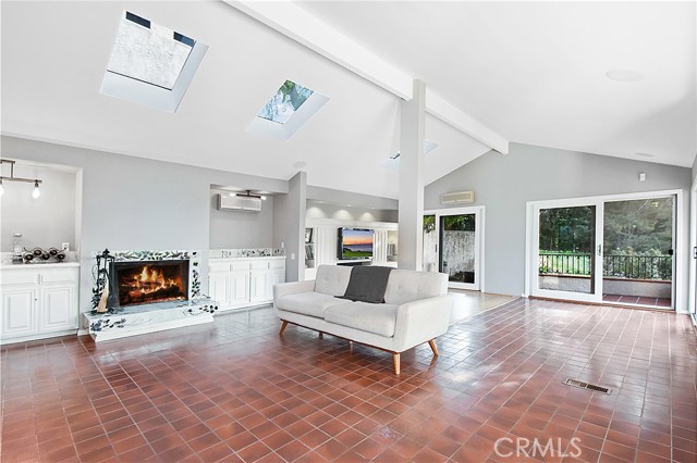 Extra large family room with a set of two sliding glass doors to welcome natural breezes.