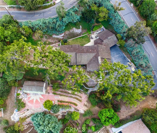 Overhead view showing home, barn and multiple pads and terraces. Secluded corner of Georgeff Rd (right) and Reata Ln (top).