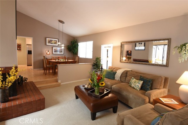 Large open living room has 2-sided fireplace with big tiled hearth!