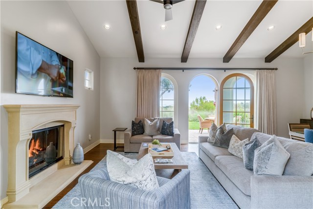 Great room with beamed ceilings and French doors to patio facing the golf course.