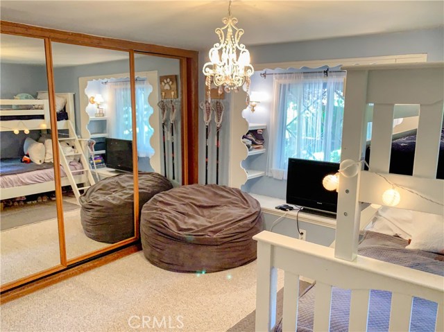 Another view of the room showing wall of closets and full length mirrors.