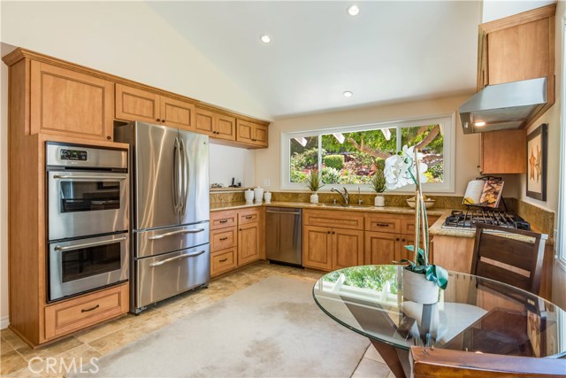 Remodeled kitchen with breakfast nook and view of the spectacular yard.