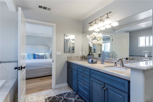 Master bathroom includes dual vanities, large spa tub and separate shower.