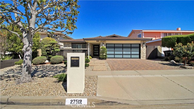 Great modern style, glass garage door, custom mailbox, low maintenance landscaping