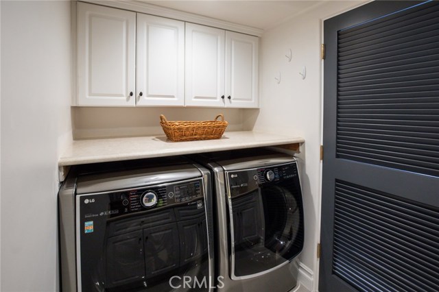 On the lowest level is another bedroom, access to the garage and this convenient laundry room
